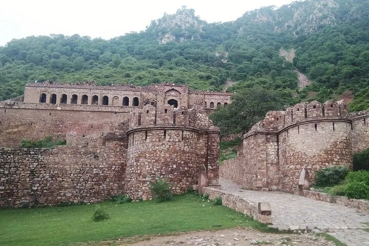 The grand stone entrance and walls of the historic Bhangarh Fort complex